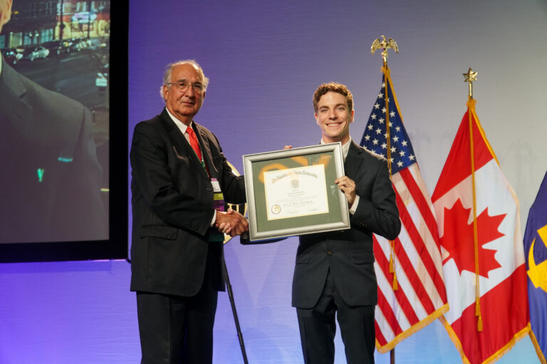 Brother Cole Fredericks accepting the Duke Flag Outstanding Undergraduate Award